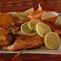 Red Snapper Fish · Served with Fried platter of plantains, fried yucca, (Akra),spicy slaw Please call to Verify...
