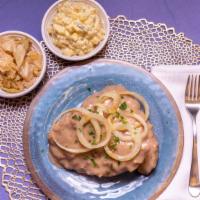 Smothered Pork Chop Meal · comes with 2 pork chops smothered in gravy with 2 sides and bread