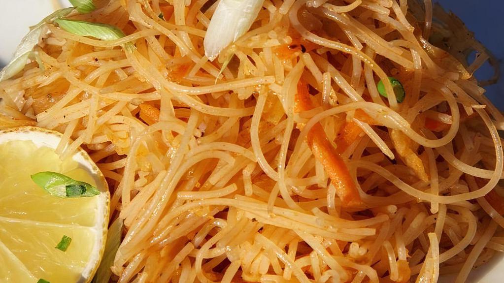 Pancit | Rice Noodles - For Four · thin seasoned rice noodle with carrots, cabbage, celery, annatto, and chicken garnished with green onions and lemons
