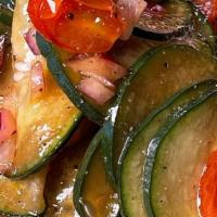 Cucumber Salad - Single · cucumber, grape tomatoes, and red onions tossed in a soy sauce, vinegar, and garlic dressing