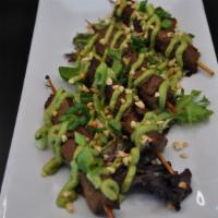 Chocho Beef · Skewered sweet soy marinated beef tips, pan roasted and topped with peanuts
and avocado driz...