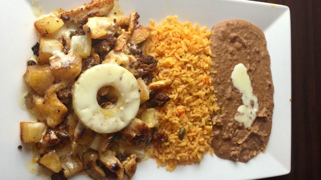 Chorizo Pollo · Chicken strips mix with chorizo (Mexican sausage), pinapple, topped with melted cheese and served with rice and beans.