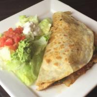 Shrimp Quesadilla Rellena · A flour tortilla grilled and stuffed with shrimp, rice, cheese, grilled onions, bell peppers...