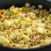 Pineapple Fried Rice · Stir-fried rice with eggs pineapple peas carrots and onions.