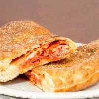 Roman Turnover · Sliced steak with melted mozzarella cheese, tapped with mushrooms, spicy italian sausage and...