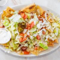 Nacho Supreme · Served with refried beans, choice of meat, melted cheese, topped with lettuce, tomato, onion...