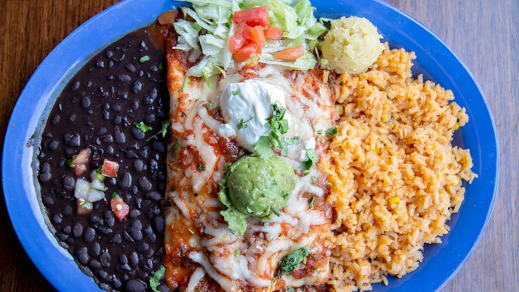 (New) Fajita Burrito · Choice of grilled chicken or steak, or both! With red and green peppers, onions and Monterey jack cheese inside a fresh flour tortilla. Topped with red chile sauce, served with rice & refried beans.