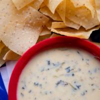 Queso Dip · White jalapeño cheddar cheese, Swiss, onions, tomatoes, red peppers, diced green chiles, and...