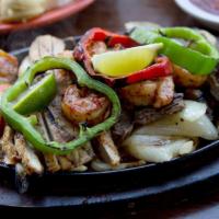 Al Carbon Fajitas · Your choice of top quality meat served with rice, cowboy beans, sour cream, guacamole, pico ...