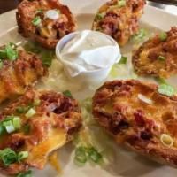 Potato Skins · crispy baked potato skins stuffed with bacon, melted cheddar cheese, served with sour cream,...