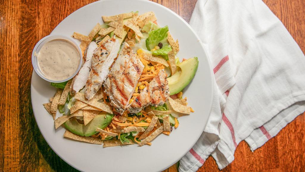 Southwest Salad · Grilled marinated chicken breast strips, black beans, corn, cheddar cheese, chopped tomatoes, and avocado slices over mixed greens. Topped with crunchy tortilla strips served with chipotle ranch dressing.