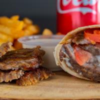 Beef Shawarma (Combo) · Marinated thin slices of beef cooked on a rotisserie and served in bread with tomatoes, onio...