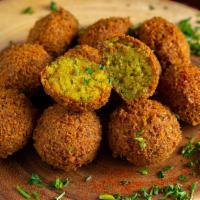 Falafel · Vegetarian. Seasoned ground chickpeas and fresh vegetables shaped into pies and deep-fried.