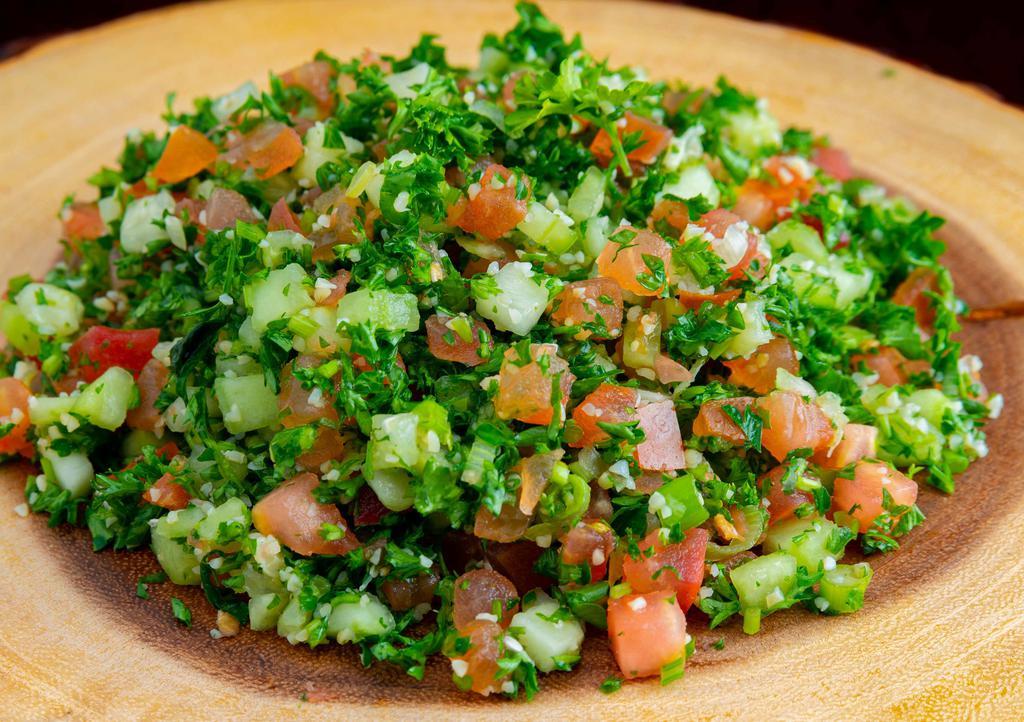 Tabouleh · Freshly diced tomatoes, onions, parsley, cucumber, and cracked wheat with a magic touch of olive oil and lemon juice.