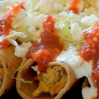 4 Taquitos Dorados · Fried crispy rolled corn tortilla with meat stuffing and topped with lettuce, salsa verde, o...