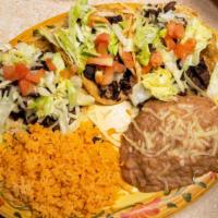 Shrimp Taco Dinner (2 Pcs.) · Topped with cabbage salad and cilantro. Served with rice and beans. Corn or flour tortilla.