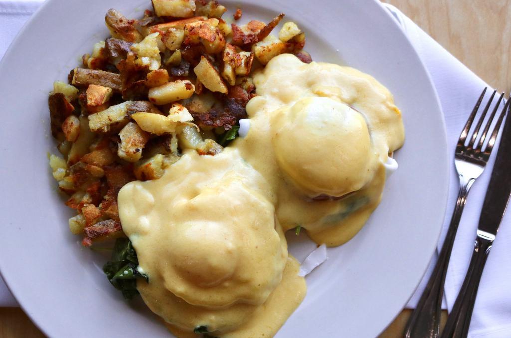 Benedict Florentine · Sautéed kale, poached eggs, fried tomato, hollandaise sauce served over english muffin