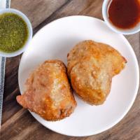 Meat Samosas-Chicken · Two Crisp patties stuffed with seasoned ground meat, peas, and Indian herbs and spices.