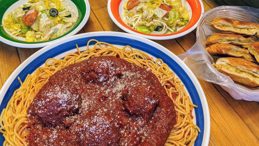 Family Spaghetti · Over 2lbs of spaghetti in our homemade sauce, 4 meatballs, a garlic bread with cheese, and a quart of salad with our house vinaigrette.  Feeds a family of 4!!!