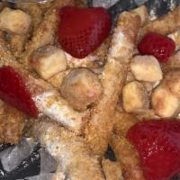 Strawberry Cheesecake Fries · Our golden fried funnel cake fries , powdered sugar, topped with diced sugar infused strawbe...