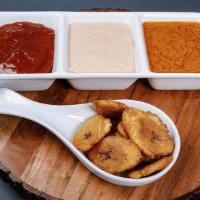 Tostones · Twice fried slices of plantains served with our garlic mojo sauce.