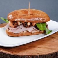 Tripleta Sandwich · Our house special with slow roasted pork, country ham, slow cooked steak with lettuce, tomat...