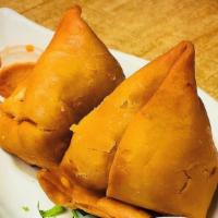 Samosas (2 Pieces) · Triangle savory pastries filled with spicy potatoes and peas.