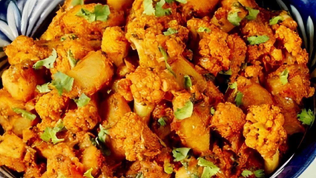 Aloo Gobi* · Fresh cauliflower and potatoes cooked with ginger, garlic, tomatoes, onions, and spices.