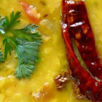 Tadka Dal * · Yellow lentils cooked with onions and tomatoes, garnished with cilantro.