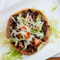 Sopes · Thick cut tortilla, beans, lettuce, tomato, cheese, and your choice of meat.