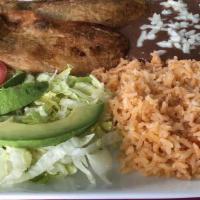 Chile Rellenos · Two poblano peppers stuffed with Cotija cheese, covered in egg whites and deep fried. Served...