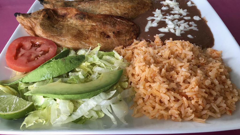 Chile Rellenos · Two poblano peppers stuffed with Cotija cheese, covered in egg whites and deep fried. Served with a side of rice, beans and tortillas.