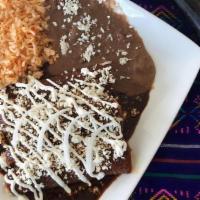 Enchiladas De Mole · Three rolled corn tortillas stuffed with shredded chicken or cheese smothered in our sweet m...