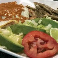 El Tiburon A La Mexicana · Grilled steak strips cooked to simmer in a tomato sauce with sliced tomatoes, onions and jal...