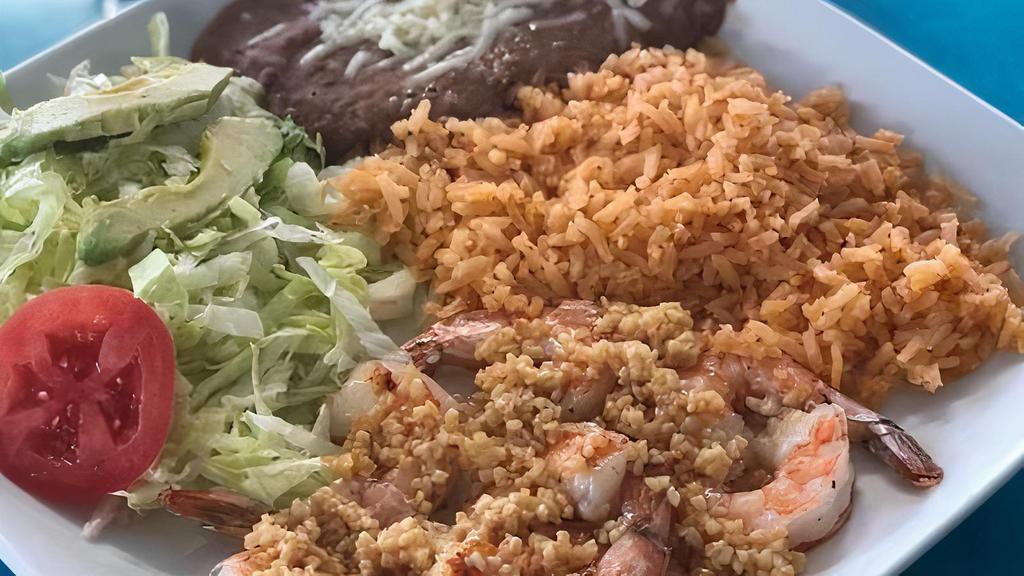 Al Mojo De Ajo- Shrimp · Shrimp smothered in garlic. Served with a side of rice, side salad and tortillas.
