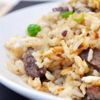 Beef Fried Rice · Rice stir fried with bits of beef onions carrots and peas in soy sauce.