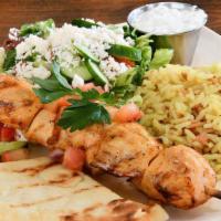 Grilled Chicken Souvlaki · Chicken breast, rice pilaf, french fries or feta fries, side salad, tzatziki, and pita bread.