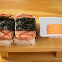 Spam Musubi · Grilled Spam on top of a block of rice, wrapped together with nori in the tradition of Japan...