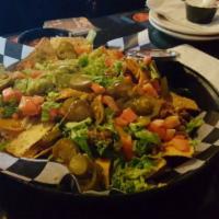 Nacho Grande · Fresh tortilla chips covered with melted cheddar cheese, diced tomatoes, lettuce and jalapeñ...