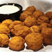 Jalapeño Poppers · Golden fried jalapeños stuffed with cream cheese and served with a side of ranch.
