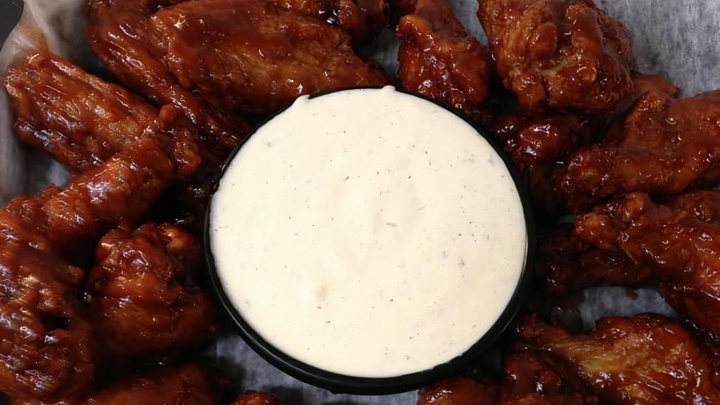 Chicken Wings · Marinated and fried, then tossed in your choice of sauce. Served with celery sticks and choice of ranch or blue cheese dip.