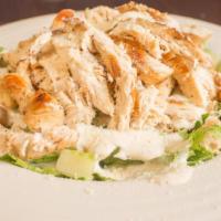 Caesar Salad · Crisp romaine lettuce tossed with our homemade creamy caesar dressing, parmesan cheese and t...