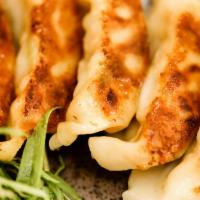 Veggie Gyoza (8) · Japanese pan-fried pot stickers with vegetable filling.