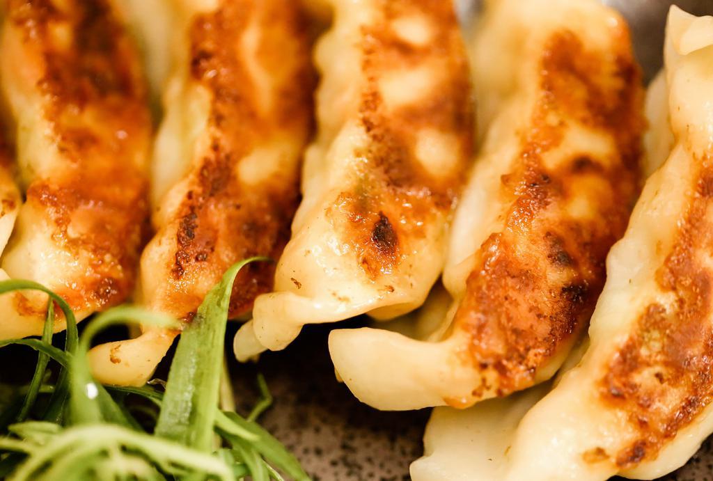 Veggie Gyoza (8) · Japanese pan-fried pot stickers with vegetable filling.