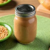 Peanut Sauce - 16 Oz Jar · Creamy, smooth, nutty. Our rockstar and. most popular sauce, featuring organic. peanut butte...