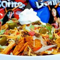 Nachos Grande · DORITOS chips, topped with chicken or ground beef, shredded lettuce, squeeze cheese, diced t...