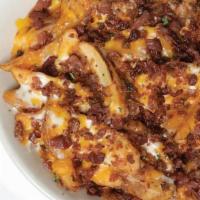 Loaded Fries · Seasoned wedge-cut fries baked with mozzarella and cheddar cheese. Topped with bacon and ser...