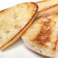 Garlic Bread · Grilled and sprinkled with Parmesan cheese.  Try it baked with cheese add $1.