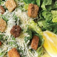 Caesar  · Freshly chopped romaine lettuce topped with shaved Parmesan cheese and croutons.