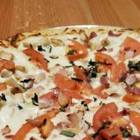 Small Chicken Ranch Pizza · Grilled chicken, roma tomatoes, basil & rasher bacon with a ranch base.